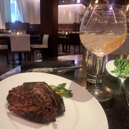 rpm steakhouse- steak on the plate with cocktail