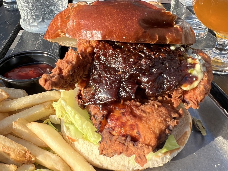 Empire Burger & Brew fried chicken sandwich with homemade jam and fries