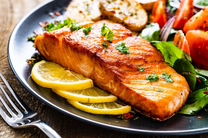 baked salmon with lemons and green ingredients