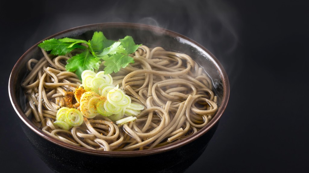Soba noodles with vegetables on a dark background