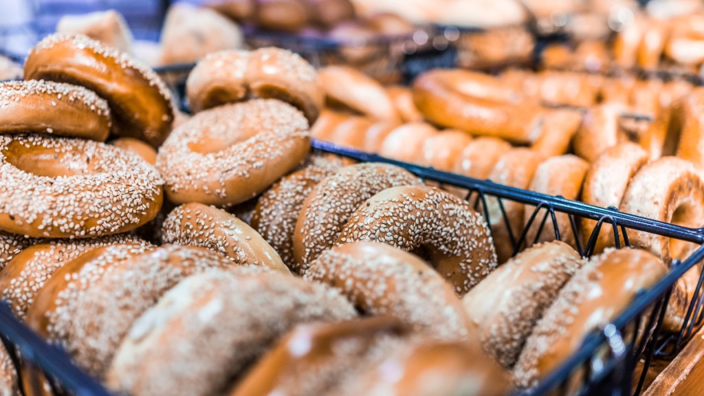 a large amount of gluten free bagels with sesame seeds