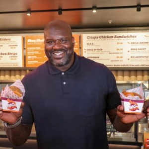 Shaq inside a big chicken restaurant
