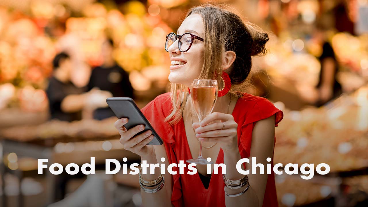 Smiling woman in a red blouse and glasses holds a phone and a champagne flute while exploring a bustling market, with “Food Districts in Chicago” text overlay—ideal for a Chicago food blog.