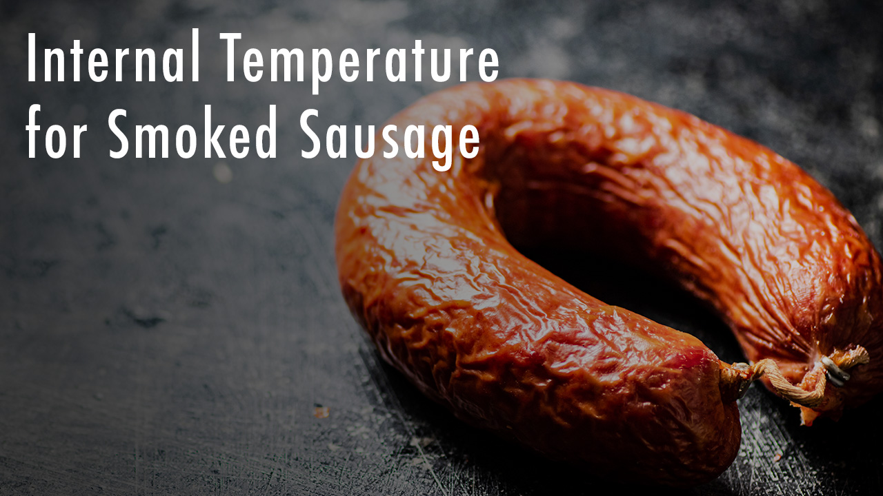 Close-up of a smoked sausage coil on a dark surface, with text overlay reading 'Internal Temperature for Smoked Sausage'